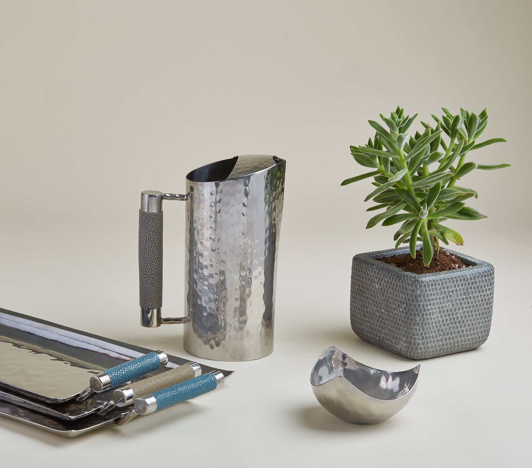Stainless steel pitchers and trays with leather accents